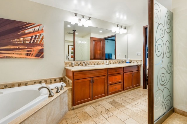 bathroom with tiled bath and vanity