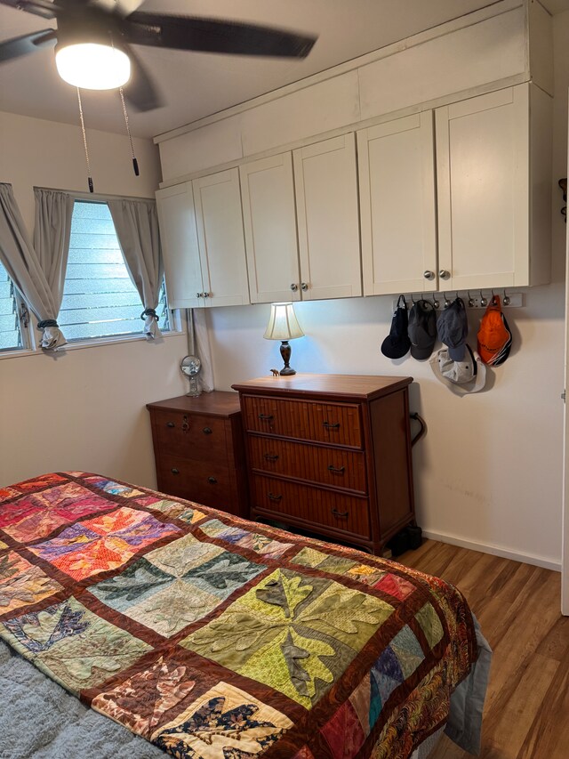 bedroom featuring hardwood / wood-style floors and ceiling fan