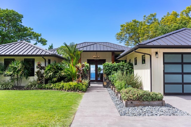 view of front of home with a front yard and a garage