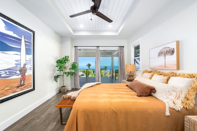 bedroom featuring access to exterior, dark hardwood / wood-style flooring, wood ceiling, a tray ceiling, and ceiling fan