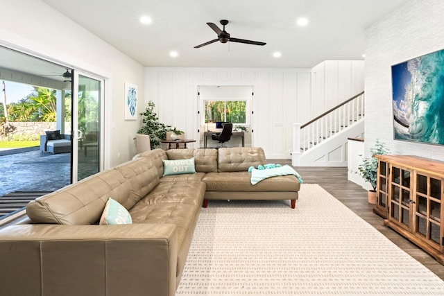 living room with dark hardwood / wood-style floors and ceiling fan