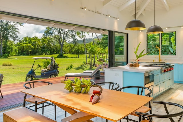 sunroom featuring lofted ceiling with beams