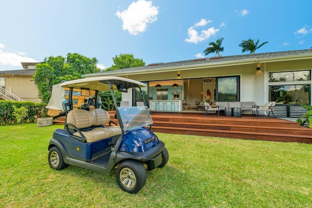 rear view of house with a lawn and a wooden deck