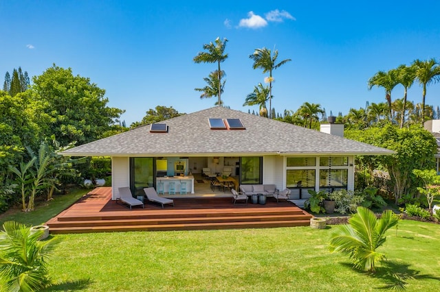 rear view of property with an outdoor living space, a yard, and a deck