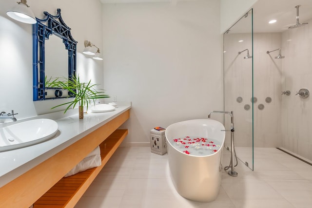 bathroom with tile patterned flooring, vanity, and shower with separate bathtub