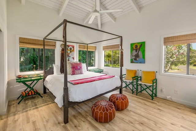 bedroom featuring beam ceiling, hardwood / wood-style flooring, ceiling fan, and wooden ceiling