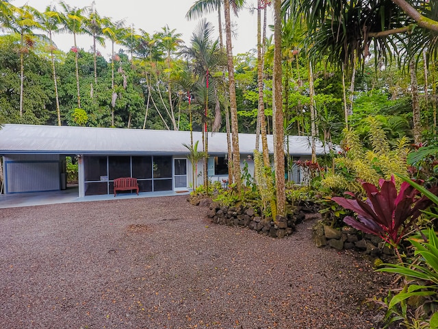 view of front facade featuring a sunroom and a carport