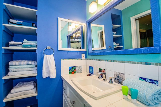 bathroom with vanity and tasteful backsplash