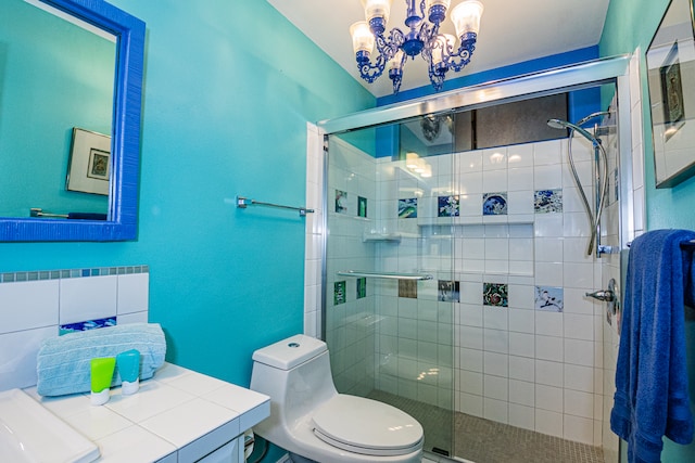 bathroom featuring a chandelier, toilet, and walk in shower