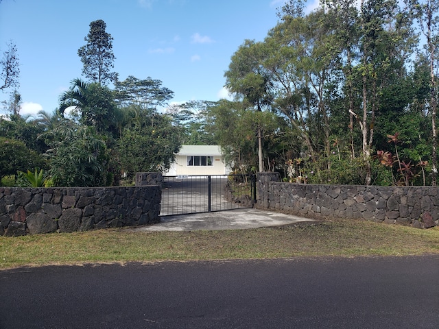 view of gate featuring a fenced front yard