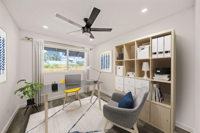 office space featuring ceiling fan and dark hardwood / wood-style flooring