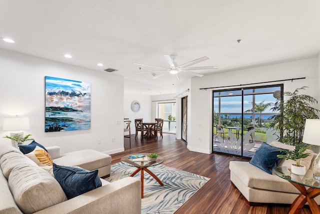 living room with ceiling fan and dark hardwood / wood-style flooring