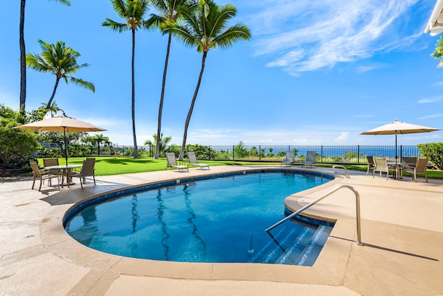 view of pool with a lawn and a patio area