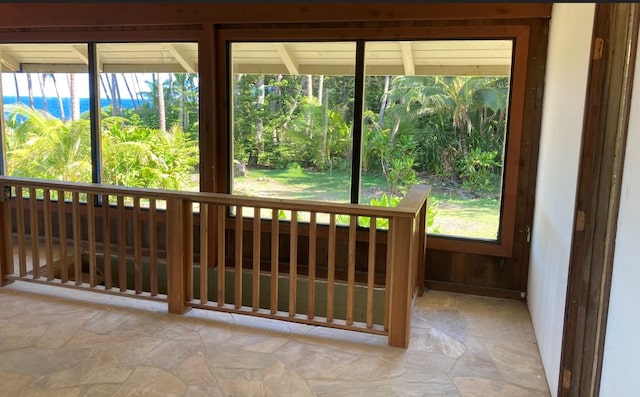 unfurnished sunroom with plenty of natural light