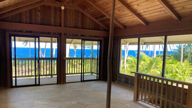 unfurnished sunroom with wood ceiling, a water view, and lofted ceiling with beams