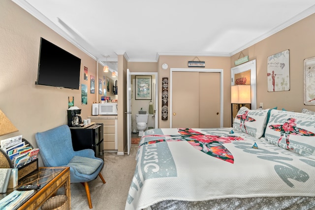 carpeted bedroom with ensuite bathroom, crown molding, and a closet