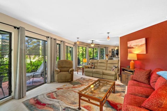 living room featuring plenty of natural light, ceiling fan, light colored carpet, and ornamental molding