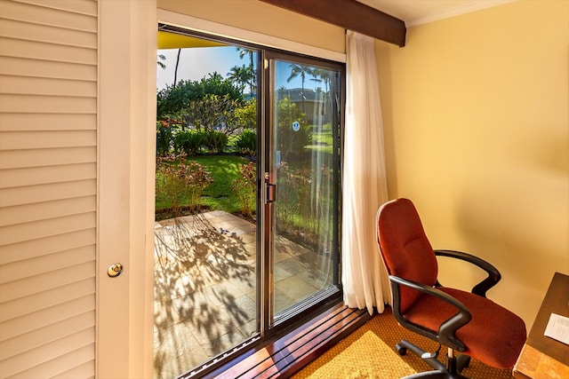 doorway to outside featuring beamed ceiling