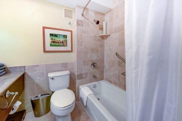 full bathroom featuring shower / bath combo, vanity, tile walls, tile patterned flooring, and toilet