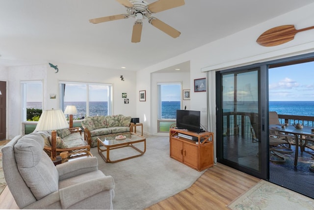 living room featuring light hardwood / wood-style floors and ceiling fan