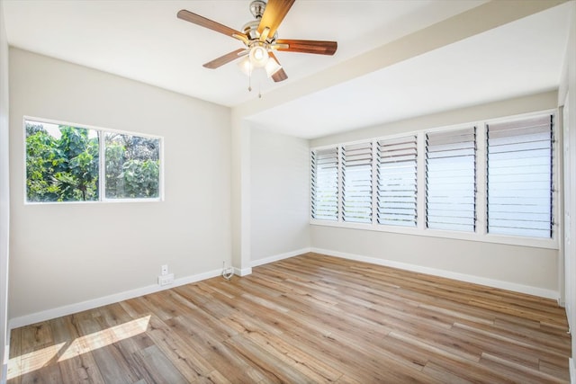 unfurnished room with ceiling fan, plenty of natural light, and light wood-type flooring