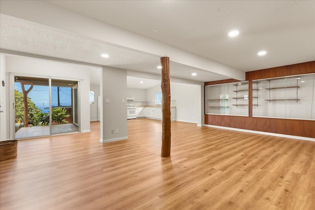 basement featuring a textured ceiling and light wood-type flooring