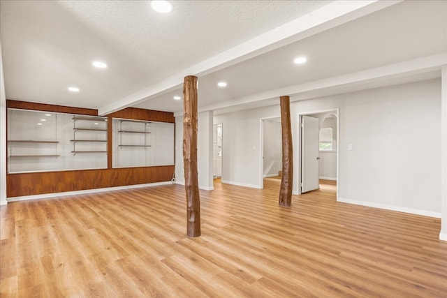 basement with a textured ceiling and light wood-type flooring