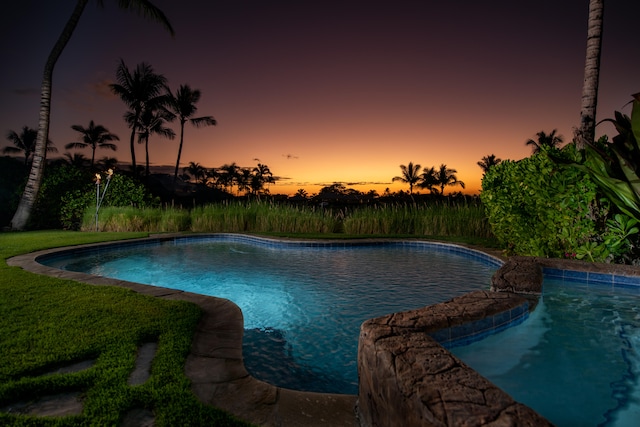 view of pool at dusk