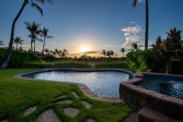 view of pool at dusk