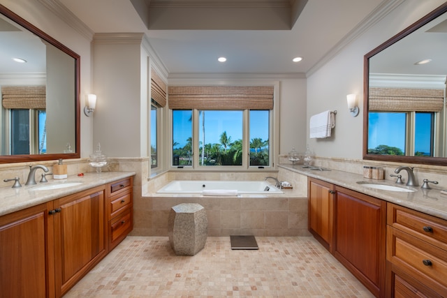 bathroom with vanity, a relaxing tiled tub, and crown molding