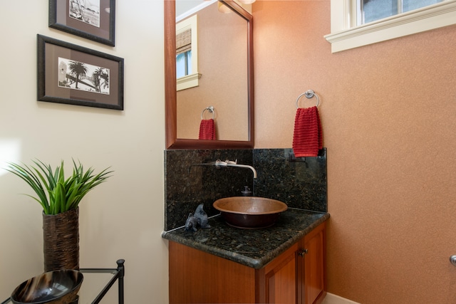 bathroom featuring vanity, a wealth of natural light, and tasteful backsplash