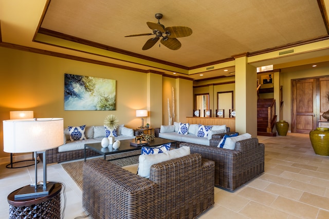 tiled living room featuring ceiling fan, crown molding, and a tray ceiling