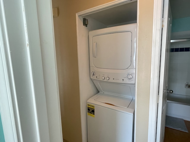 washroom featuring stacked washer / dryer