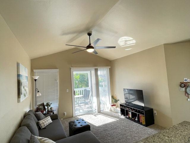 living room featuring carpet flooring, ceiling fan, and lofted ceiling