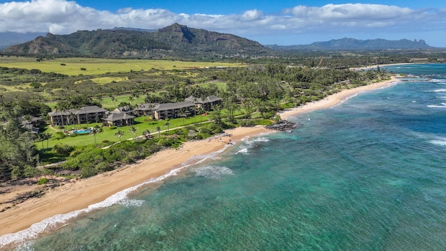 birds eye view of property with a water and mountain view and a beach view