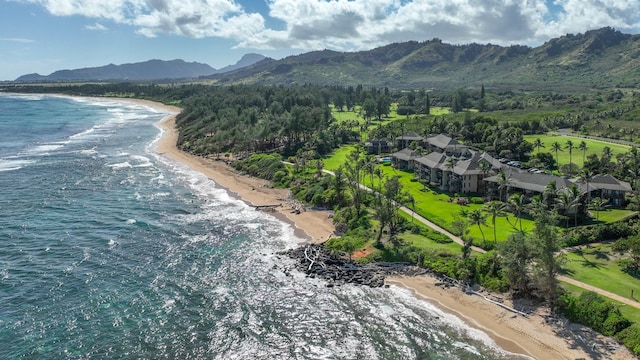 birds eye view of property featuring a view of the beach and a water and mountain view