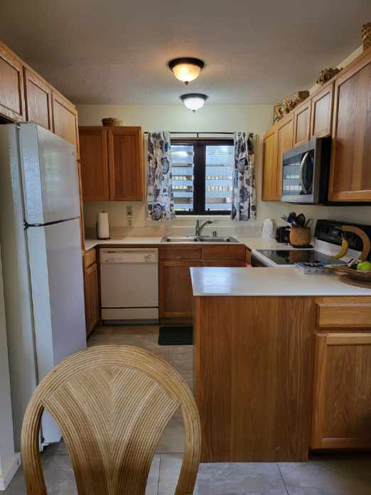 kitchen featuring sink, white appliances, and kitchen peninsula