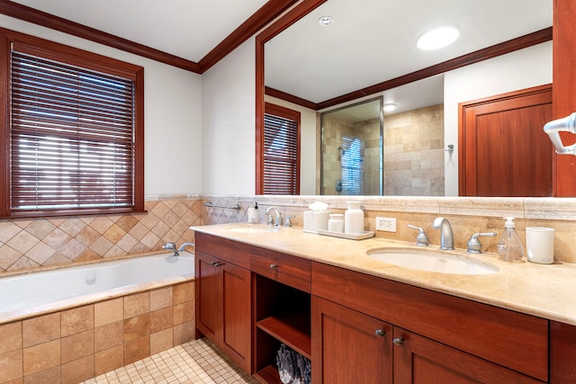 bathroom with tile patterned floors, ornamental molding, a relaxing tiled tub, and vanity