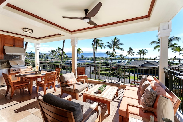 view of patio / terrace featuring a grill, an outdoor kitchen, a water view, ceiling fan, and an outdoor hangout area