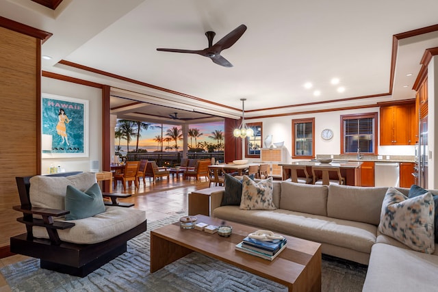 living room with ceiling fan, ornamental molding, tile patterned floors, and a raised ceiling