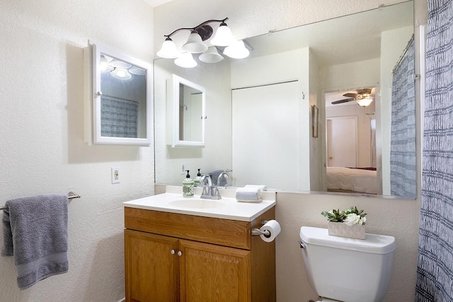 bathroom featuring vanity, ceiling fan, and toilet