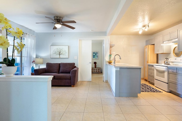 kitchen with white range with electric cooktop, sink, ceiling fan, gray cabinets, and light tile patterned flooring