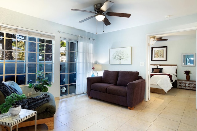 living room featuring light tile patterned floors and ceiling fan