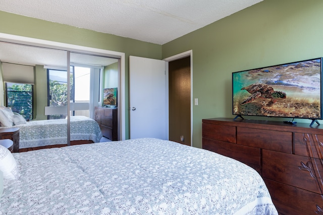 bedroom with a textured ceiling and a closet