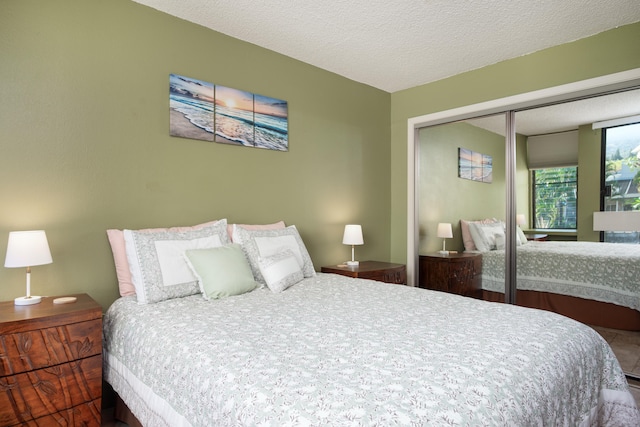 bedroom with a textured ceiling and a closet