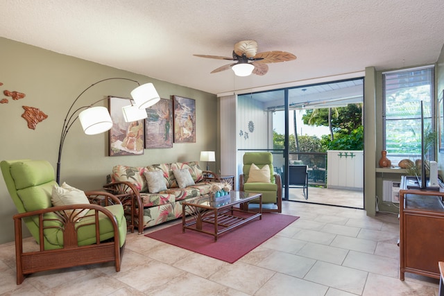 living room with floor to ceiling windows, ceiling fan, and a textured ceiling