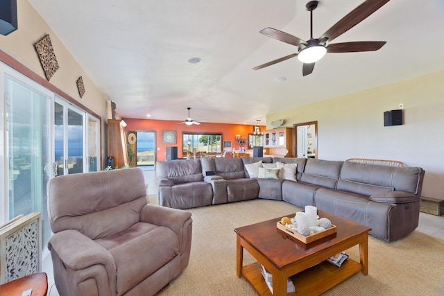 carpeted living room featuring ceiling fan and lofted ceiling