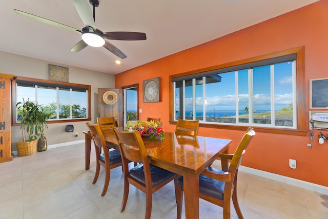 dining space featuring light tile patterned floors, ceiling fan, and a healthy amount of sunlight