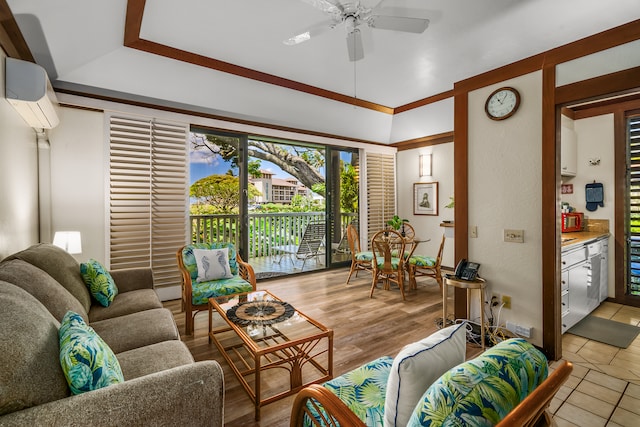 living room featuring a wall mounted air conditioner, light hardwood / wood-style floors, and ceiling fan