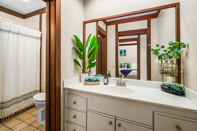 bathroom featuring tile patterned floors, vanity, and toilet